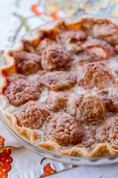 a pie sitting on top of a table covered in meatballs