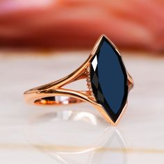 Univers's Eye- an Art Deco-inspired engagement ring that captures the mysterious allure of the cosmos. Set in luxurious rose gold, this stunning piece features a 2.5-carat marquise-cut black diamond, enhanced to reveal its deep, captivating beauty. Adorned with 0.1 carats of round accent diamonds, the Univers's Eye boasts a total carat weight of 2.6, combining vintage elegance with modern sophistication. This ring is a perfect choice for those who seek a distinctive symbol of love, blending time Black Ruby Ring, Black Onyx Ring Engagement, Black Gold Ring Women, Black Stone Engagement Ring, Black Ring, Black Diamond Engagement Ring, Black Diamond Necklace, Black Diamond Studs, White Diamond Earrings