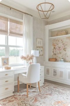 a white desk sitting under a window next to a lamp and chair in a room