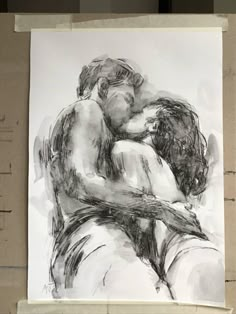 a black and white drawing of two people hugging each other on a piece of paper