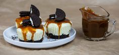 two desserts are on a plate next to a cup of chocolate and caramel