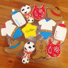 decorated cookies are arranged in the shape of cowboy hats, boots, and other items