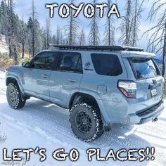 a silver four - doored vehicle is parked in the snow