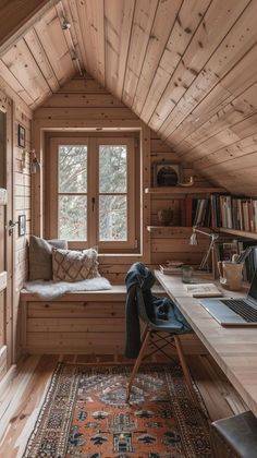 a home office with wooden walls and flooring in the corner, along with a window seat