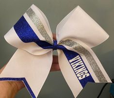 Cheer bow personalized for your teams. Bow measure approximately 7x7.  3" x 28" grosgrain ribbon with glitter heat transfer vinyl and ponytail elastic attached.  All bows are customizable: we can do it in your colors, with your team name/ mascot/logo. We do not warranty hair elastics as they are not manufactured by us.  All custom orders and bows with names/initials/monograms etc are custom made specifically for you!  They are non-returnable and non-exchangeable. Color samples available upon req Custom Cheer Bows, Glitter Heat Transfer Vinyl, Cheer Bow, Mascot Logo, Cheer Bows, Team Name, We Can Do It, Hair Elastics, Color Samples