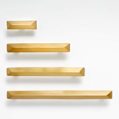 three wooden shelves are lined up against the wall