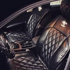 the interior of a car with black leather and pink hearts on it's seat covers