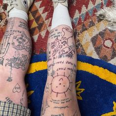 two people's legs with tattoos on them