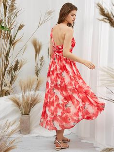 a woman in a red and white floral dress