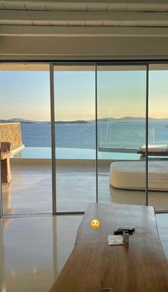 a living room with large windows overlooking the ocean