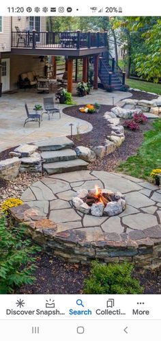 an outdoor fire pit surrounded by landscaping