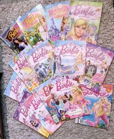 there are many barbie books on the floor