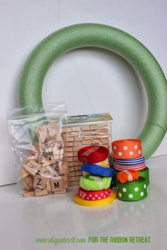 a stack of wooden blocks sitting next to a green wreath