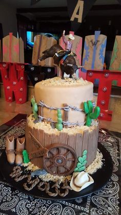 a three tiered cake decorated with horse and carriage decorations on top of a table