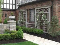 a brick house with an ornamental garden in the front yard