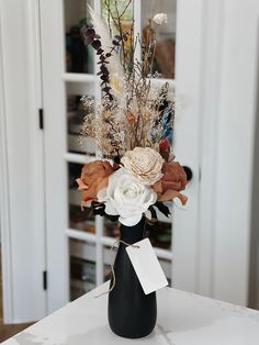 a vase filled with flowers sitting on top of a table