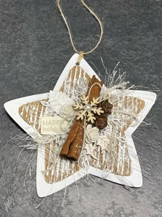 a star ornament decorated with cinnamon sticks and snowflakes