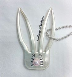 a metal keychain with a bunny face on it