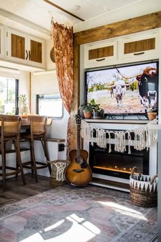 a living room filled with furniture and a flat screen tv mounted above a fire place