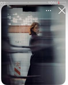 a blurry photo of a woman standing in a subway station