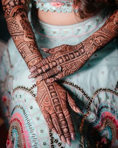 a woman's hands with hennap on her hand and the top half of her arm