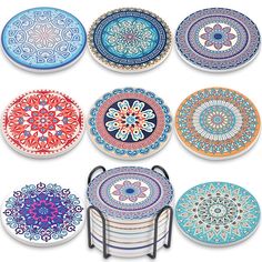 six colorful plates with designs on them and one has a metal holder in the middle