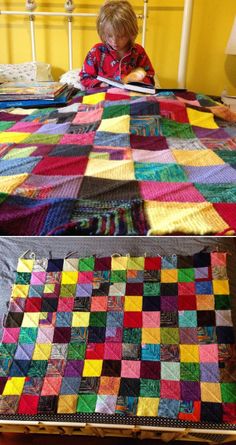 a child sitting on a bed next to a quilt