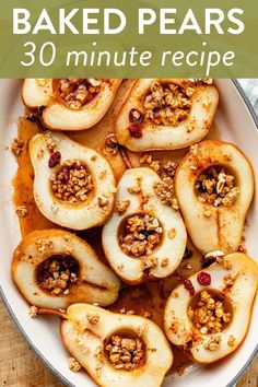 baked pears in a white bowl with walnuts on top