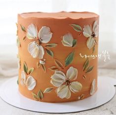 a close up of a cake on a plate with flowers painted on the frosting