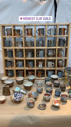 a table topped with lots of cups and bowls