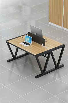 a computer desk with a laptop on it in the middle of a tiled floored room