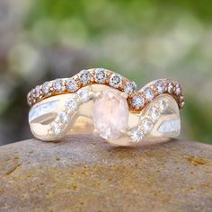 two wedding rings on top of a rock