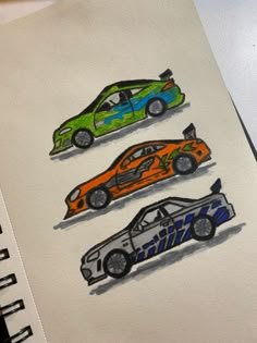 three different colored cars are shown on a piece of paper with pencils in front of them