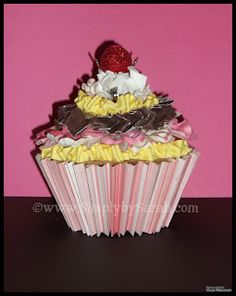 a cupcake with yellow and pink frosting on top