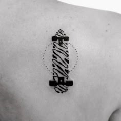 a black and white photo of a person with a zebra print tattoo on their back