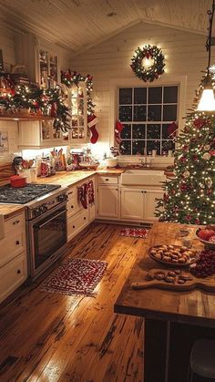 a christmas tree is in the middle of a kitchen