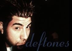 a close up of a person wearing a suit and tie with the words deftones on it