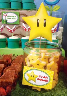 a table topped with star shaped candies and cupcakes next to each other