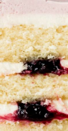 two slices of cake with blueberries and cream filling on each slice are stacked together