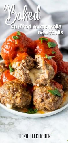 meatballs covered in marinara sauce and parsley on top of a white plate