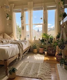 a bed room with a neatly made bed and lots of plants on the windowsill