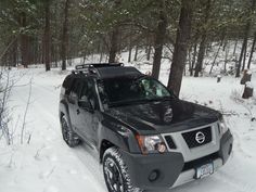 a black suv is parked in the snow