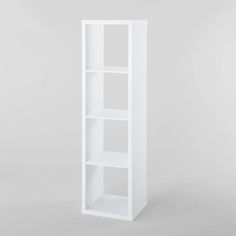 a white bookcase with three shelves on the bottom and one shelf in the middle