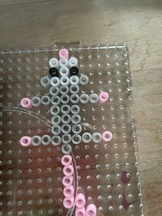 an animal made out of plastic beads sitting on top of a table