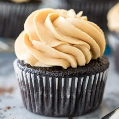 a chocolate cupcake with frosting on top