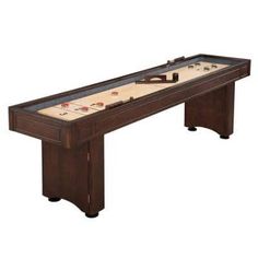 the shuffle table is made from wood and has an air hockey game on it's top