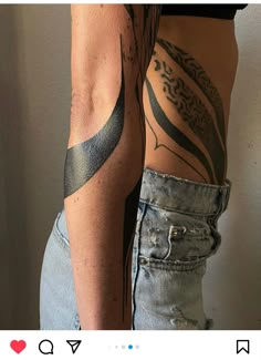 a woman with tattoos on her arm and leg