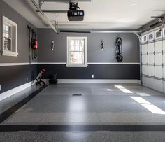 an empty garage with several bikes hanging on the wall and two doors open in front of it