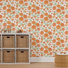 an orange flower wallpaper in a living room with baskets on the floor and a basket next to it