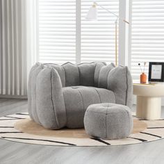 a living room with a chair and ottoman